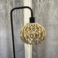 Decorative lamp with geometric design against a textured wall