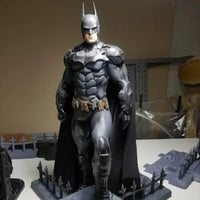 Batman figurine on a stand with a plain background