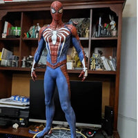 Spider-Man action figure on a stand with a bookshelf in the background